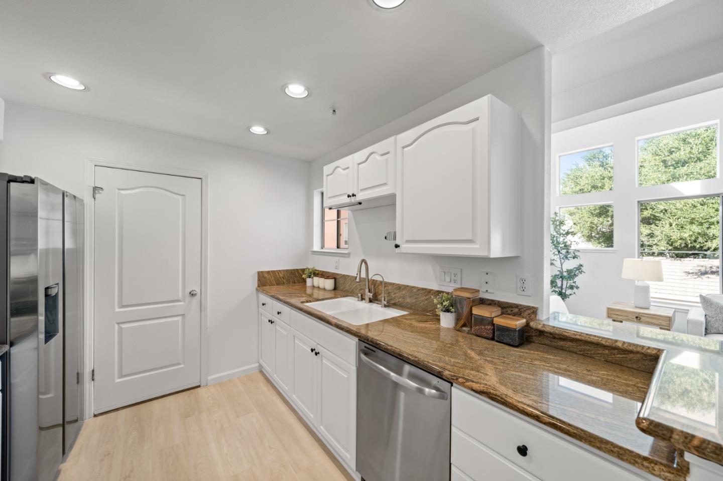 986 Alpine Terrace, Unit 4 Sunnyvale, CA 94086 - Photo 19 of 59 a kitchen with granite countertop a sink stainless steel appliances and cabinets