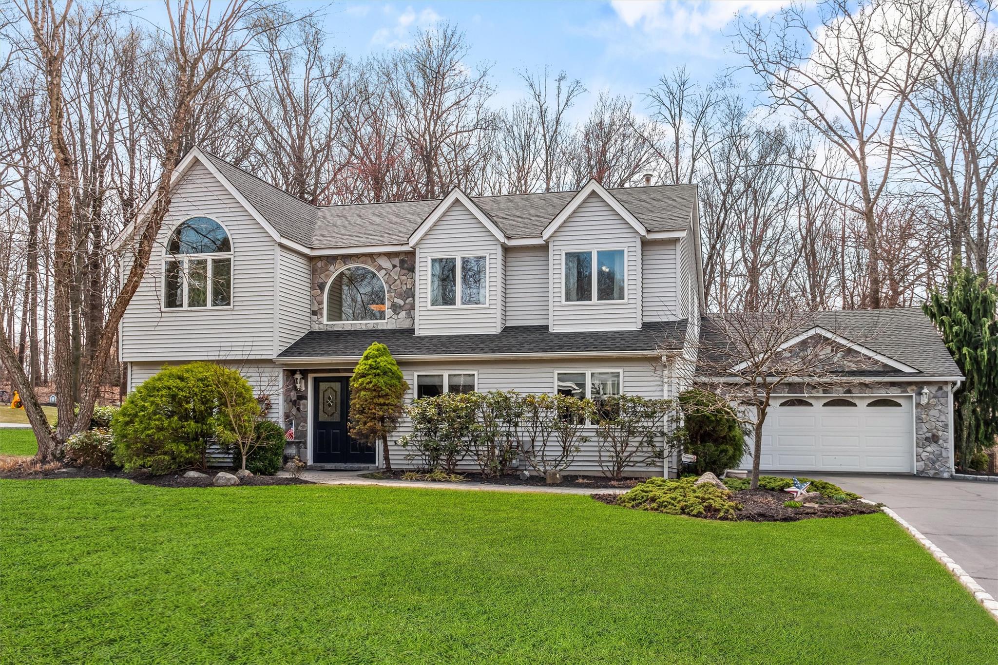a front view of a house with a garden