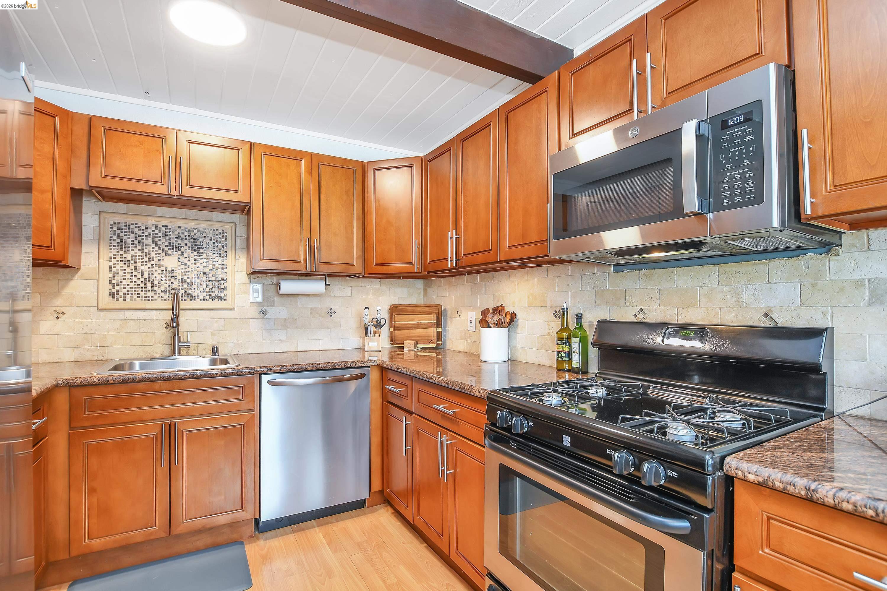 37 Beach Drive Bay Point, CA 94565 - Photo 11 of 33 a kitchen with stainless steel appliances granite countertop a stove a sink and a microwave