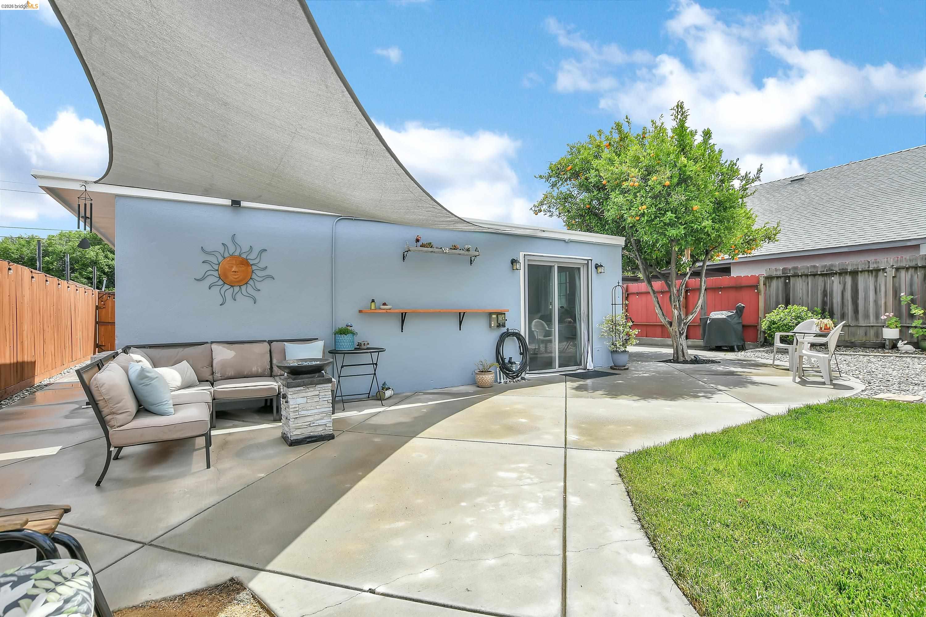 37 Beach Drive Bay Point, CA 94565 - Photo 21 of 33 a view of a patio with table and chairs potted plants with wooden fence