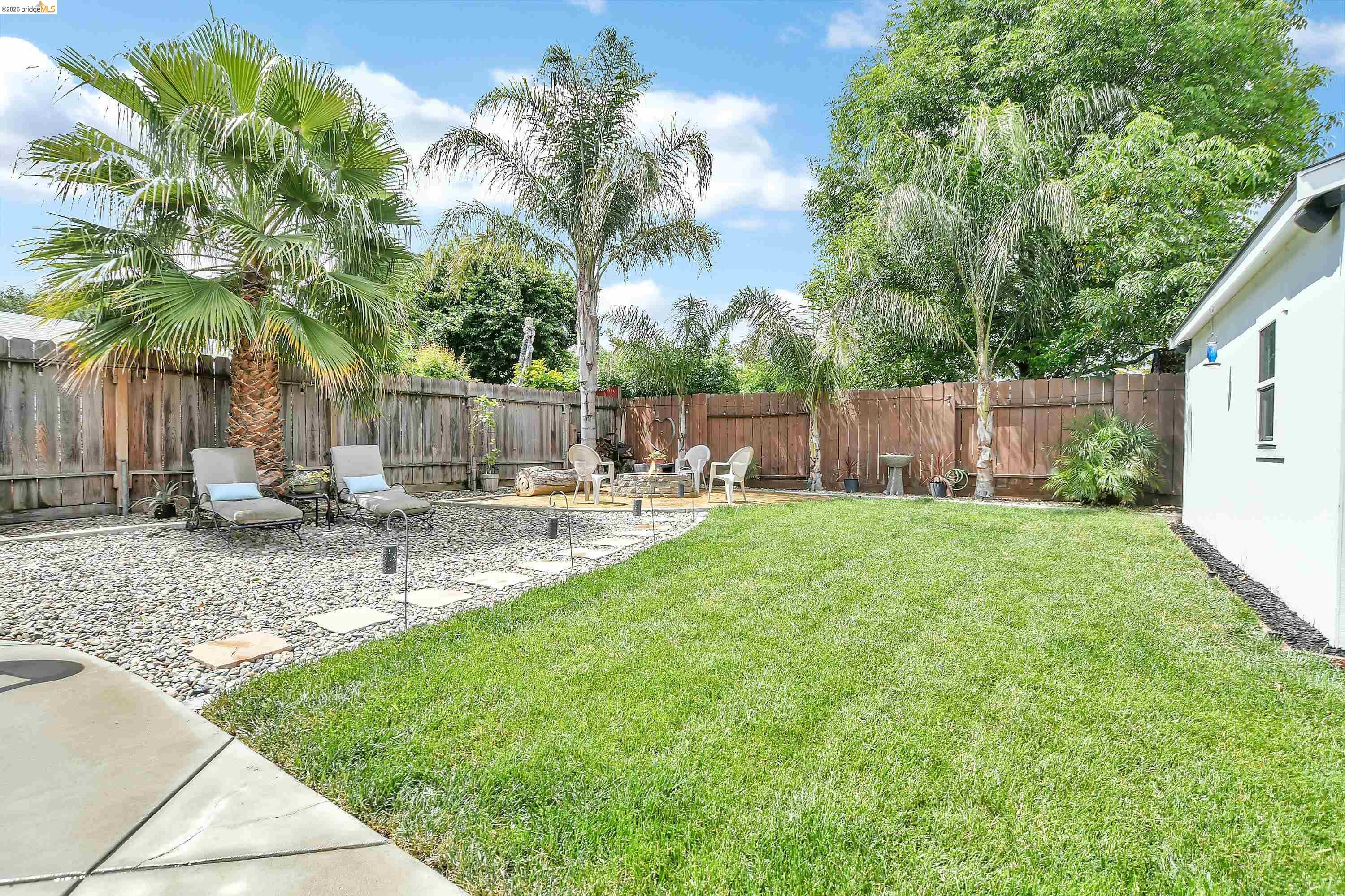 37 Beach Drive Bay Point, CA 94565 - Photo 22 of 33 a view of a backyard with a garden and palm trees