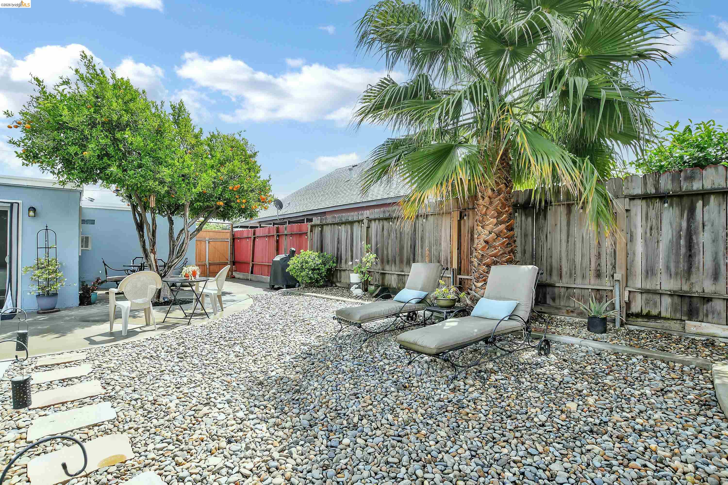 37 Beach Drive Bay Point, CA 94565 - Photo 27 of 33 a row of palm trees and a fire pit in the backyard of a house