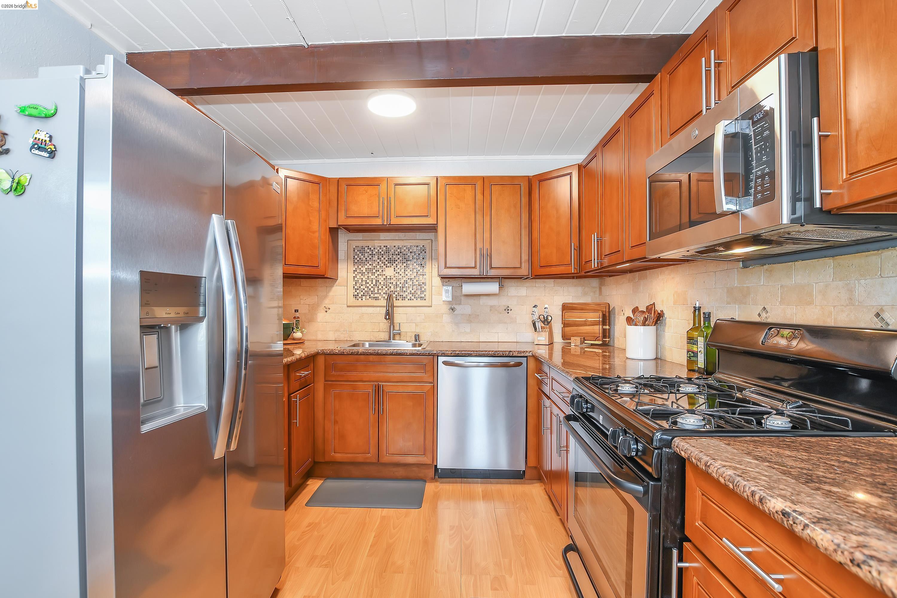 37 Beach Drive Bay Point, CA 94565 - Photo 10 of 33 a kitchen with stainless steel appliances granite countertop a stove a sink and a refrigerator
