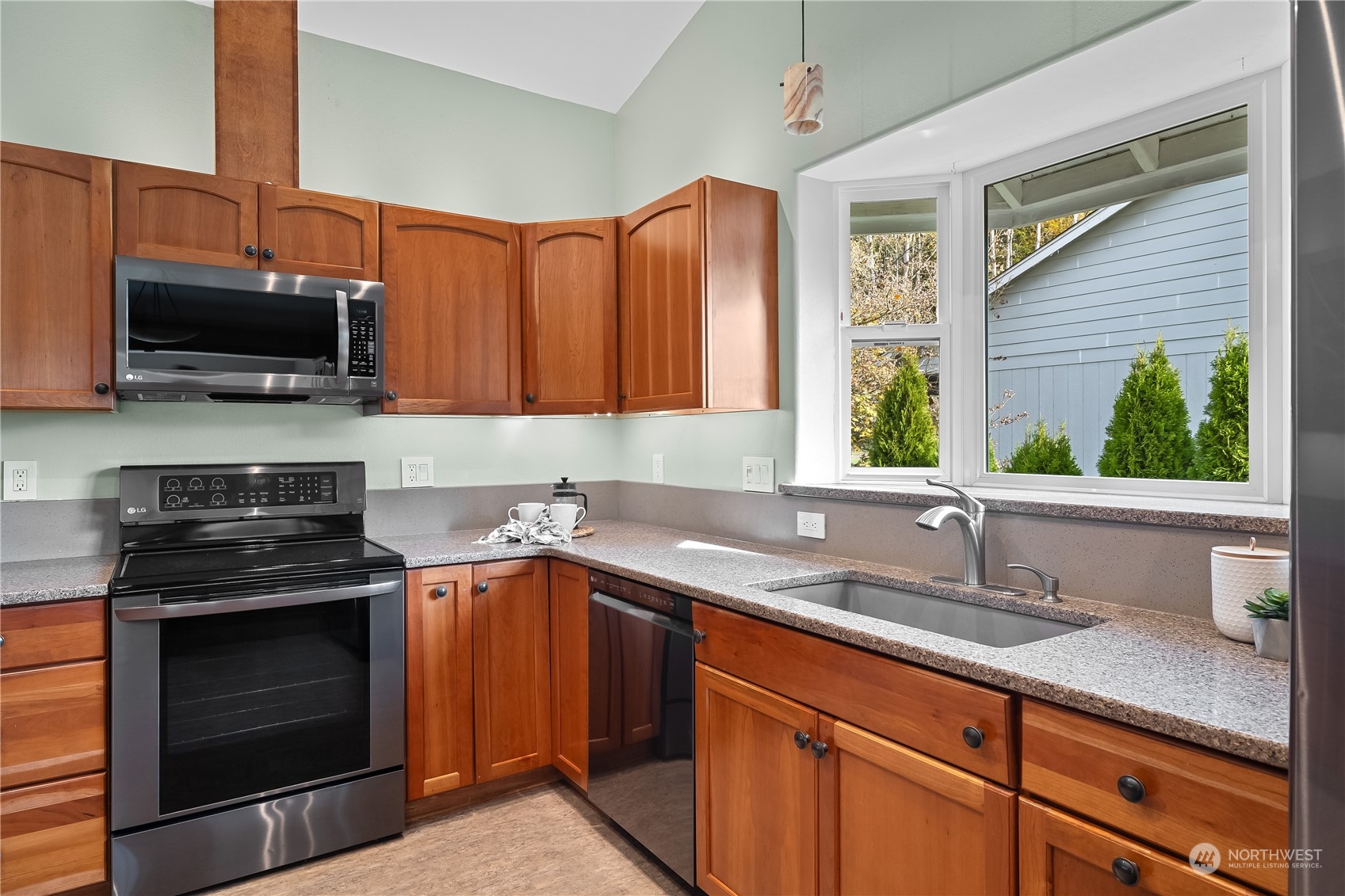 10121 Meadowside Lane Southwest Rochester, WA 98579 - Photo 11 of 35 a kitchen with stainless steel appliances a stove sink microwave and cabinets