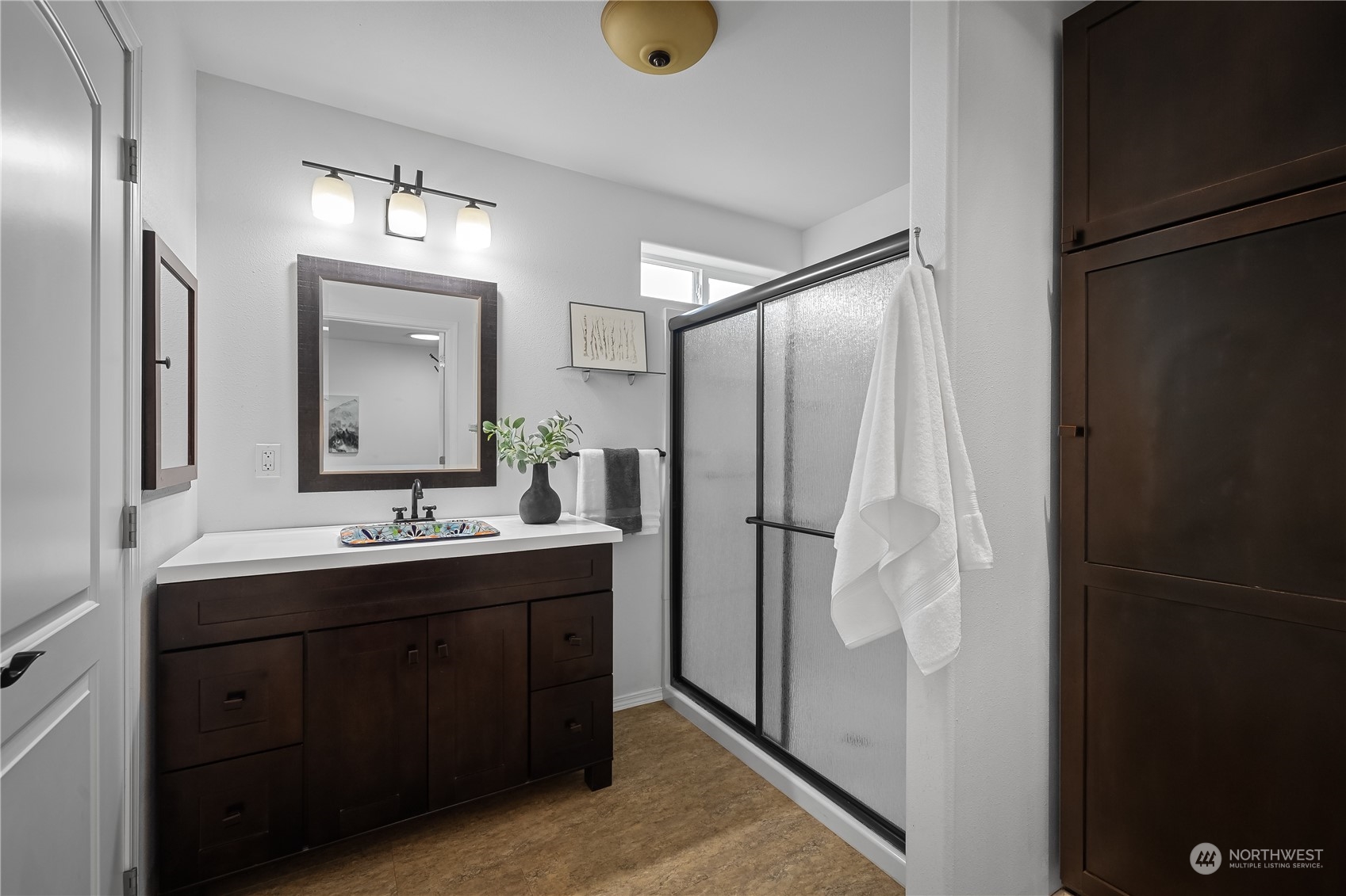 10121 Meadowside Lane Southwest Rochester, WA 98579 - Photo 17 of 35 a bathroom with a double vanity sink and mirror
