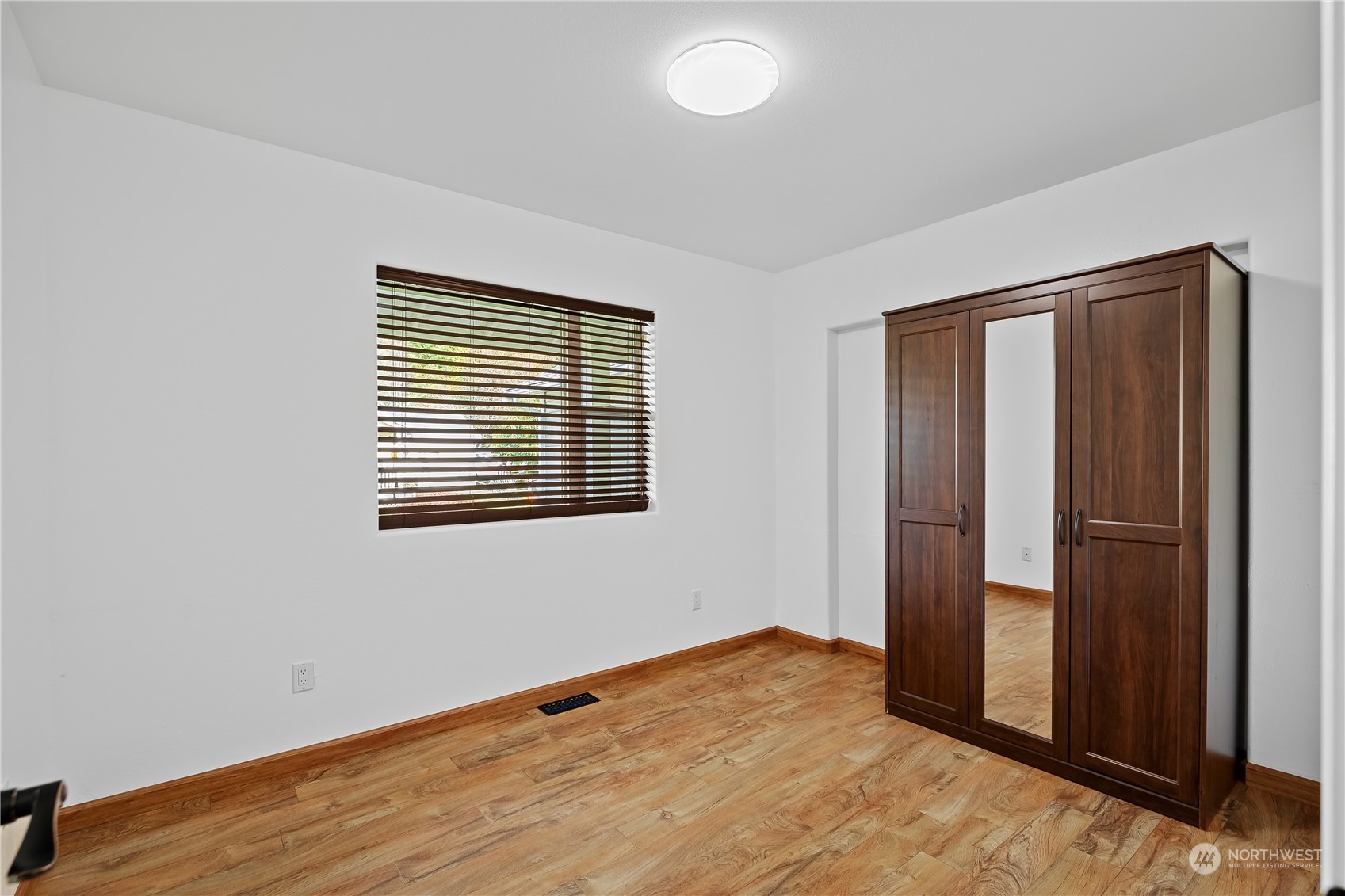 10121 Meadowside Lane Southwest Rochester, WA 98579 - Photo 22 of 35 an empty room with wooden floor and closet