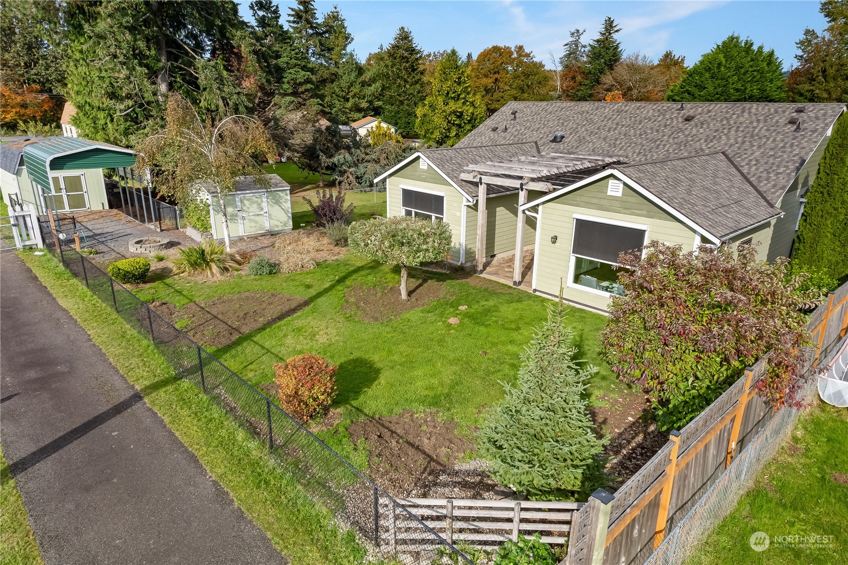 10121 Meadowside Lane Southwest Rochester, WA 98579 - Photo 28 of 35 a aerial view of a house with a yard table and chairs