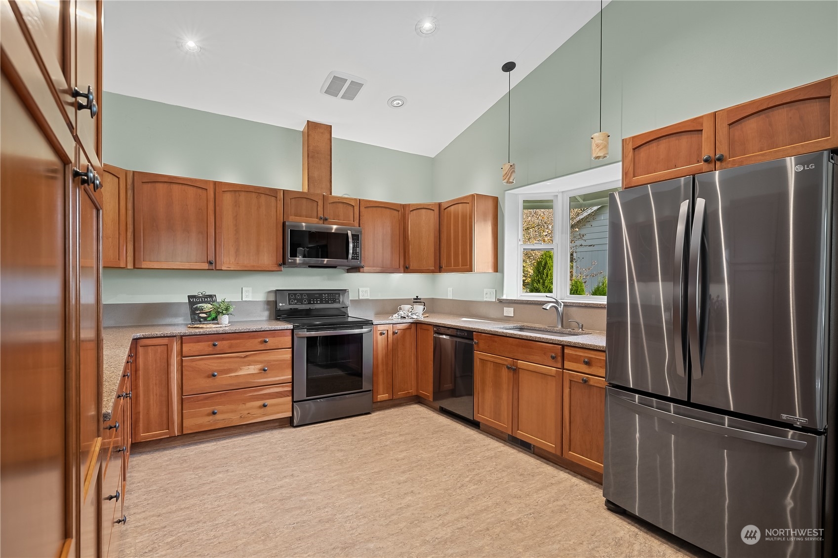 10121 Meadowside Lane Southwest Rochester, WA 98579 - Photo 10 of 35 a kitchen with stainless steel appliances granite countertop a refrigerator stove top oven and sink