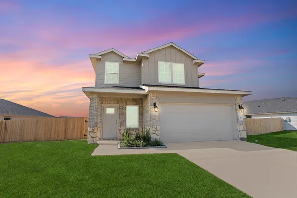 a view of a house with a yard and garage
