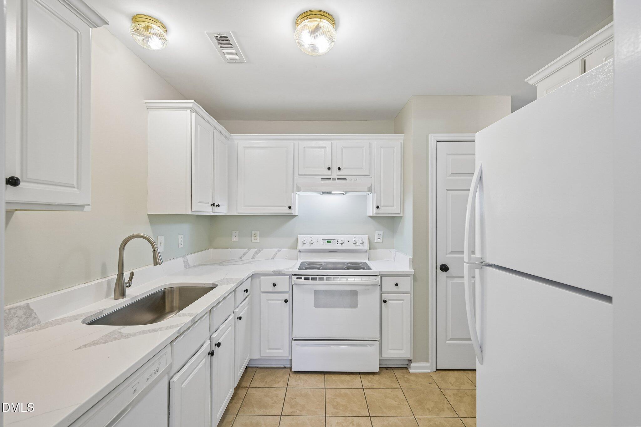 278 South Raleigh Street Angier, NC 27501 - Photo 10 of 35 a kitchen with a sink cabinets and appliances