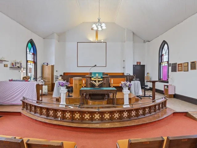 a living room with furniture chandelier and a rug