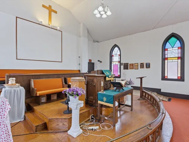 a living room with furniture a fireplace and a chandelier