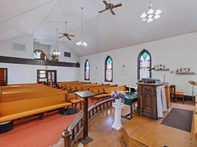 a view of a room with shelves and wooden floor