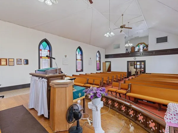 a projector room with furniture and a chandelier
