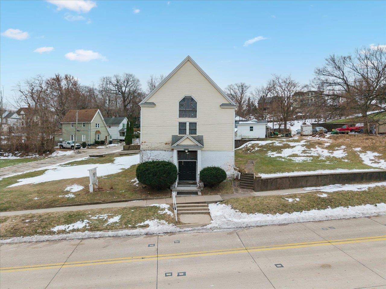 1222 7th Avenue Moline, IL 61265 - Photo 2 of 24 a view of a white house with a yard and lawn chairs