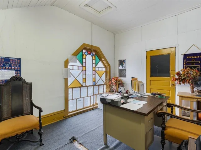 a living room with furniture and a piano