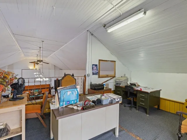 a room with table chairs and windows