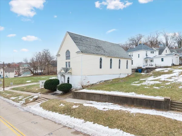 a view of a white house with a yard