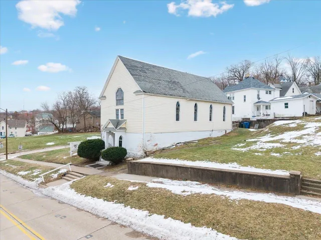 a view of a white house with a yard