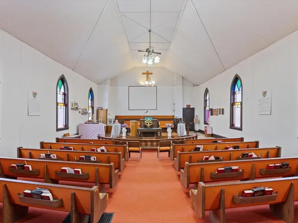 a room with gym equipment and wooden floor