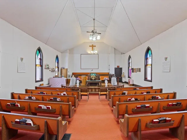 a room with gym equipment and wooden floor