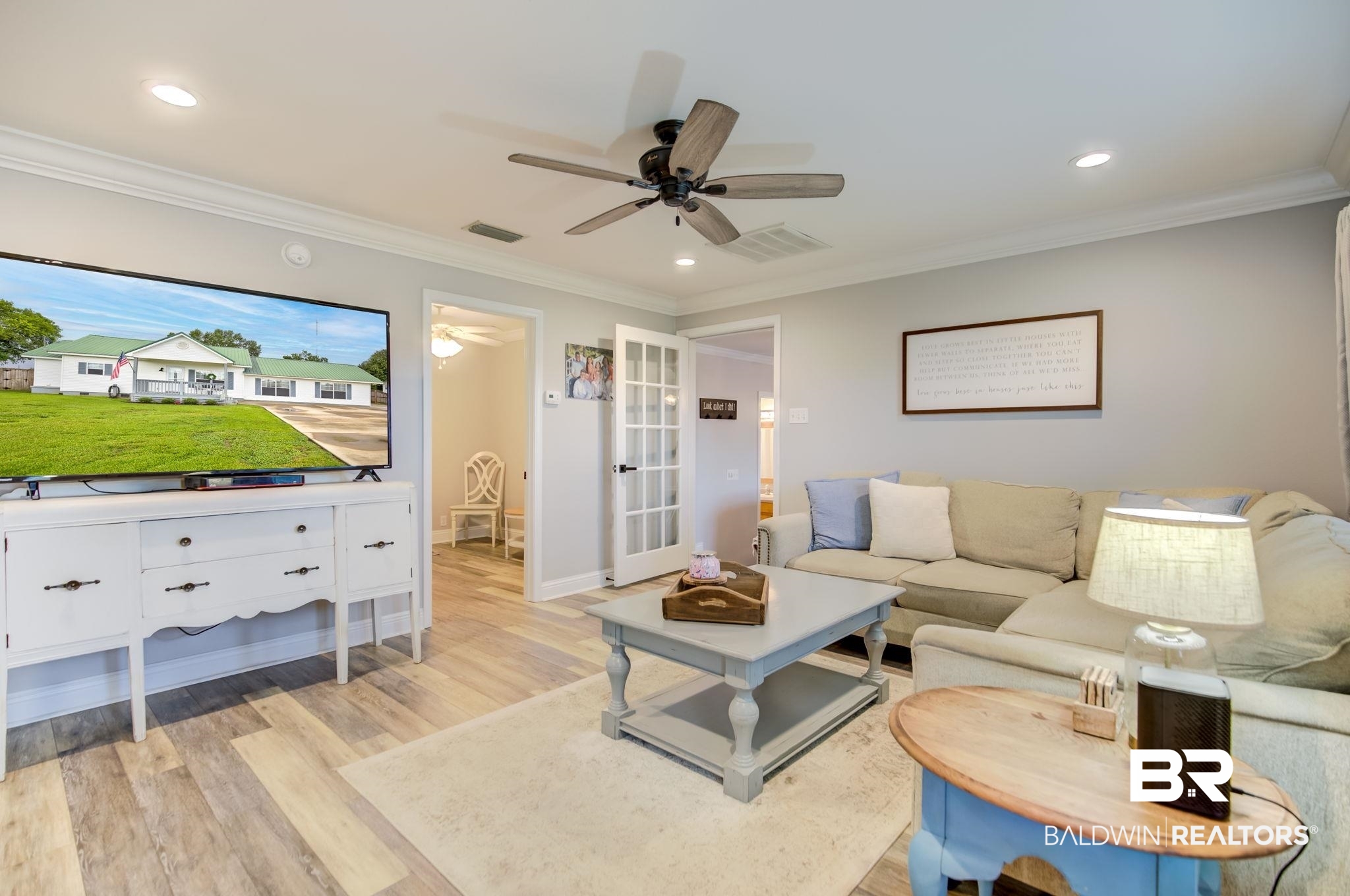 18732 Fairground Road Robertsdale, AL 36567 - Photo 7 of 46 Living room with crown molding, light wood-type flooring, and ceiling fan