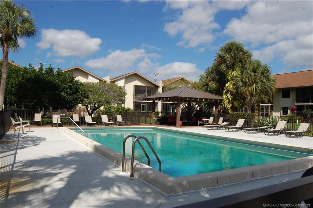 a view of a house with swimming pool and sitting area
