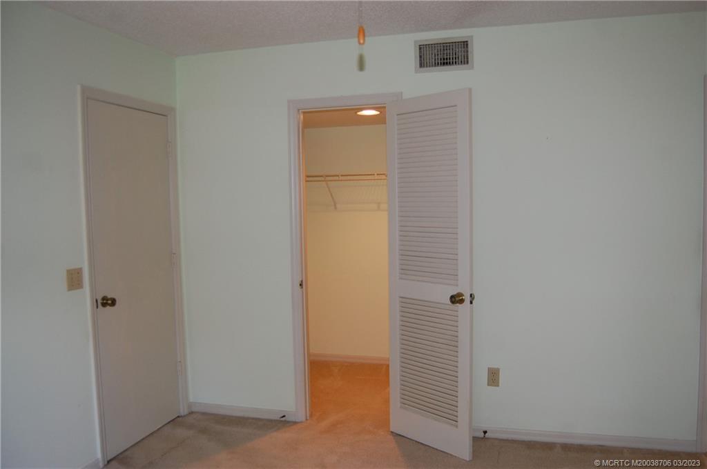 1881 Southwest Palm City Road, Unit H201 Stuart, FL 34994 - Photo 18 of 33 a view of a hallway with wooden floor and closet