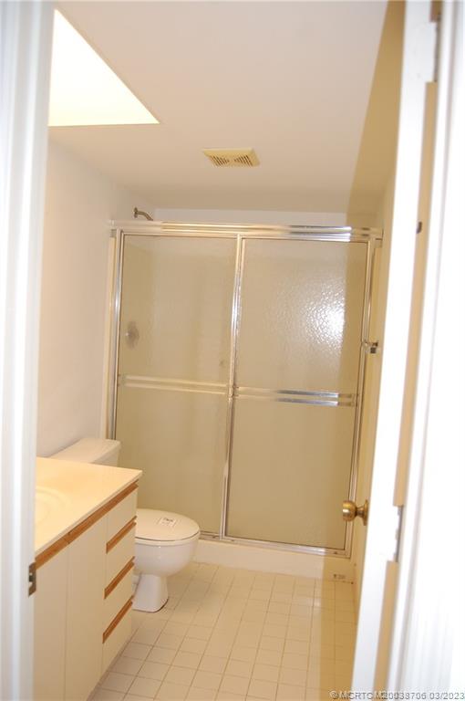 1881 Southwest Palm City Road, Unit H201 Stuart, FL 34994 - Photo 19 of 33 a bathroom with a granite countertop sink toilet and shower