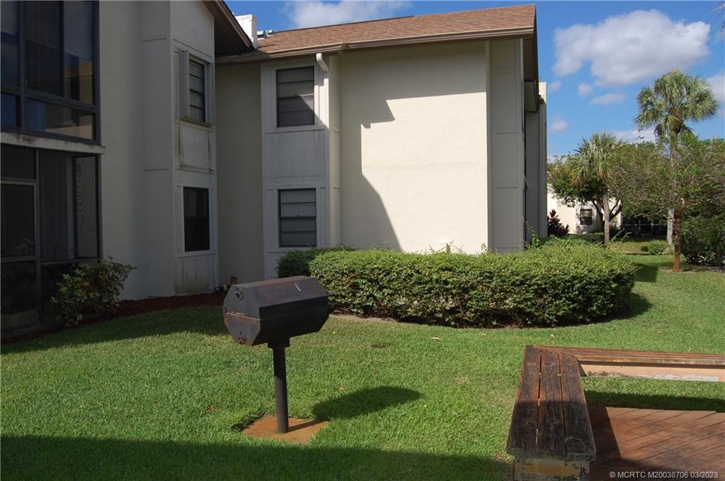 1881 Southwest Palm City Road, Unit H201 Stuart, FL 34994 - Photo 27 of 33 a front view of a house with garden
