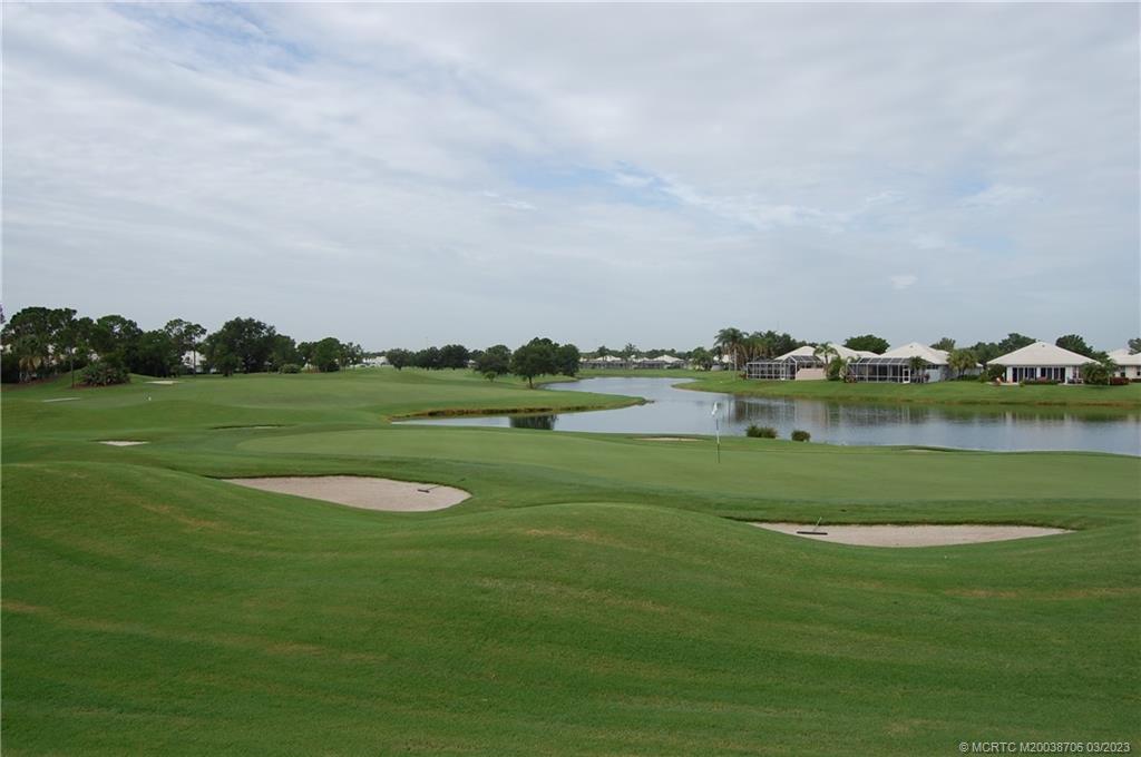1881 Southwest Palm City Road, Unit H201 Stuart, FL 34994 - Photo 30 of 33 a view of a golf course with a lake