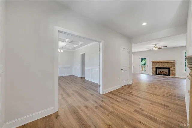 a large kitchen with stainless steel appliances a large counter top a sink a refrigerator and a window