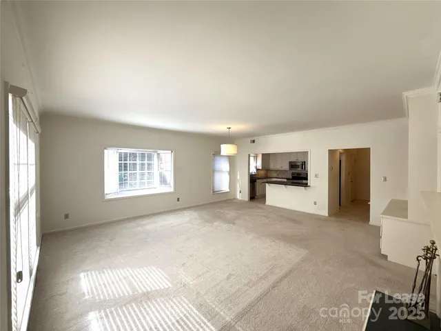 a view of a livingroom with furniture and a window