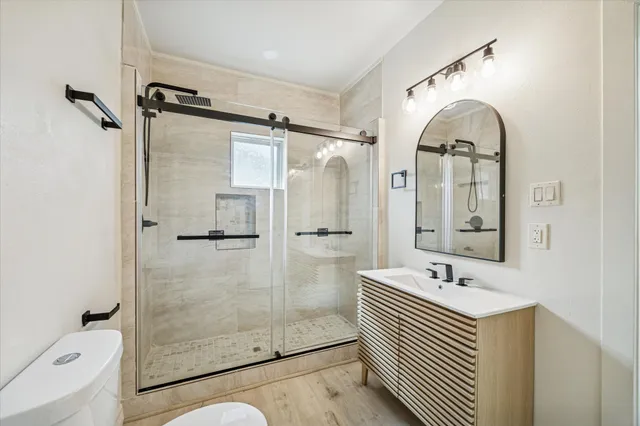 a bathroom with a sink a mirror and a shower