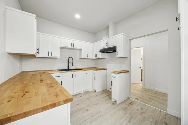 a kitchen with a sink stove and cabinets