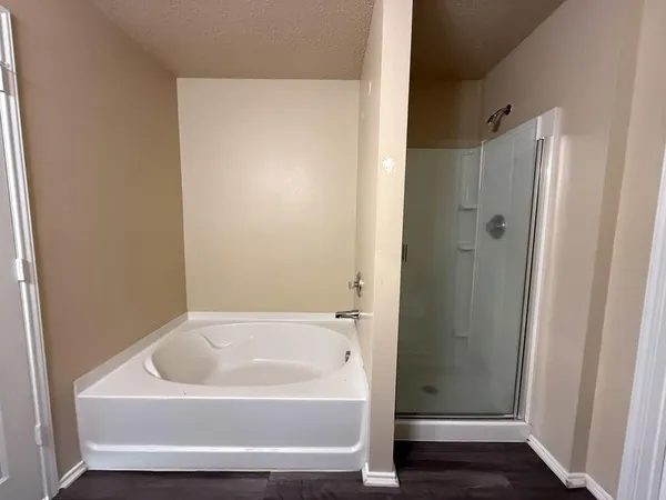 a bathroom with a tub and shower