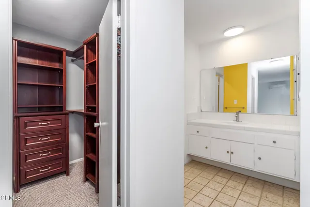 a view of walk in closet and bedroom view