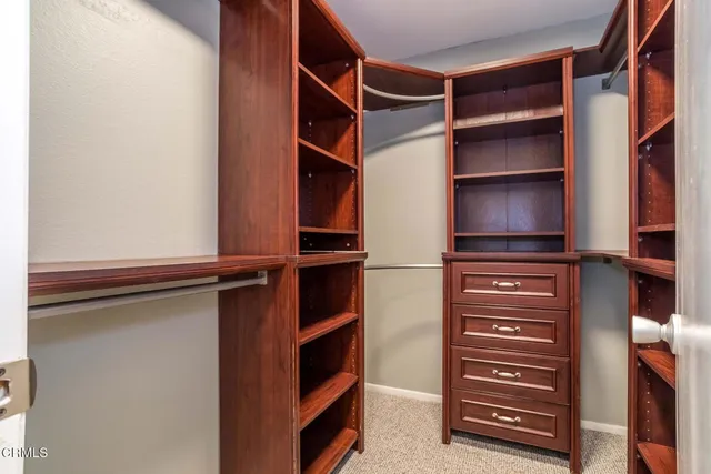 a view of walk in closet with empty racks