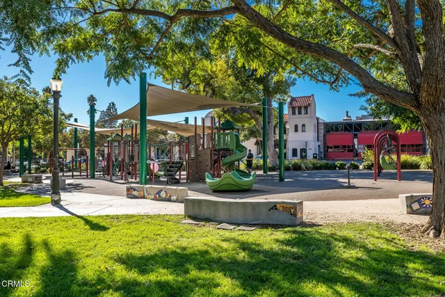 a view of a patio with a table and chairs under an umbrella