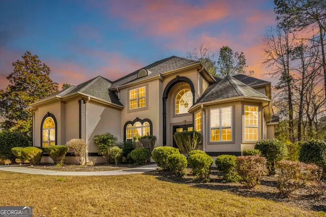 a front view of a house with a garden