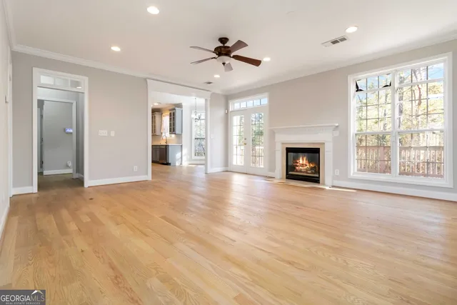 a view of an empty room with a fireplace and a window