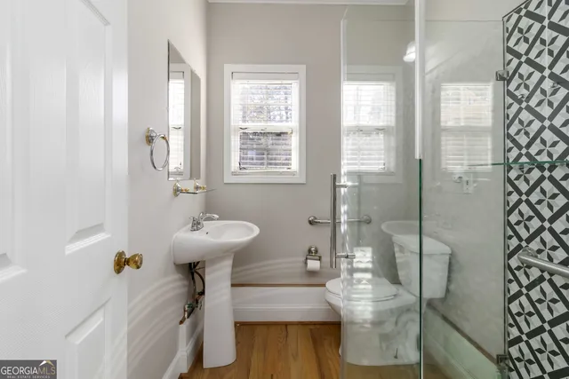 a view of a hallway with a livingroom and a bathroom