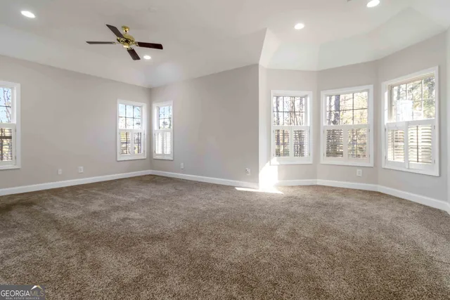 a spacious bathroom with a tub sink and mirror