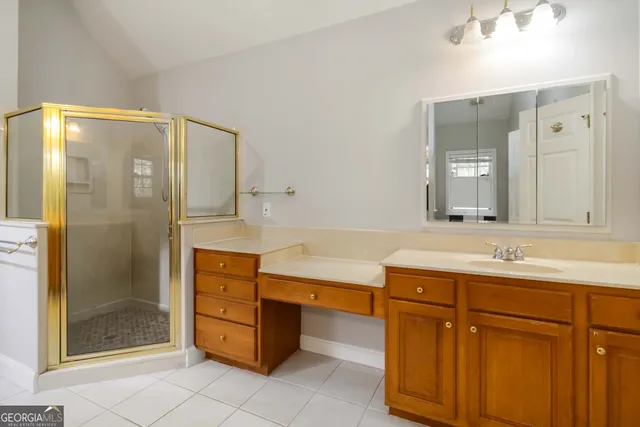 an empty room with windows and chandelier