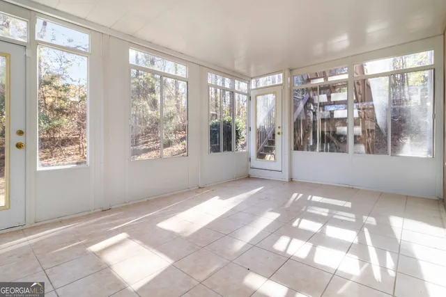 a front view of a multi story residential apartment building with yard and parking space