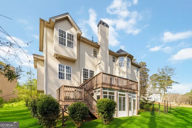 a view of a green yard with large trees