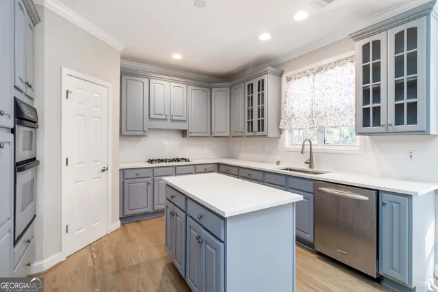 a kitchen with a sink stove and cabinets