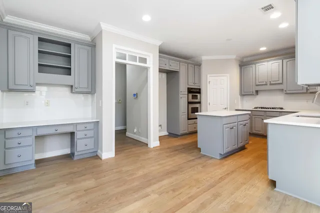 a kitchen with a stove a sink and a refrigerator