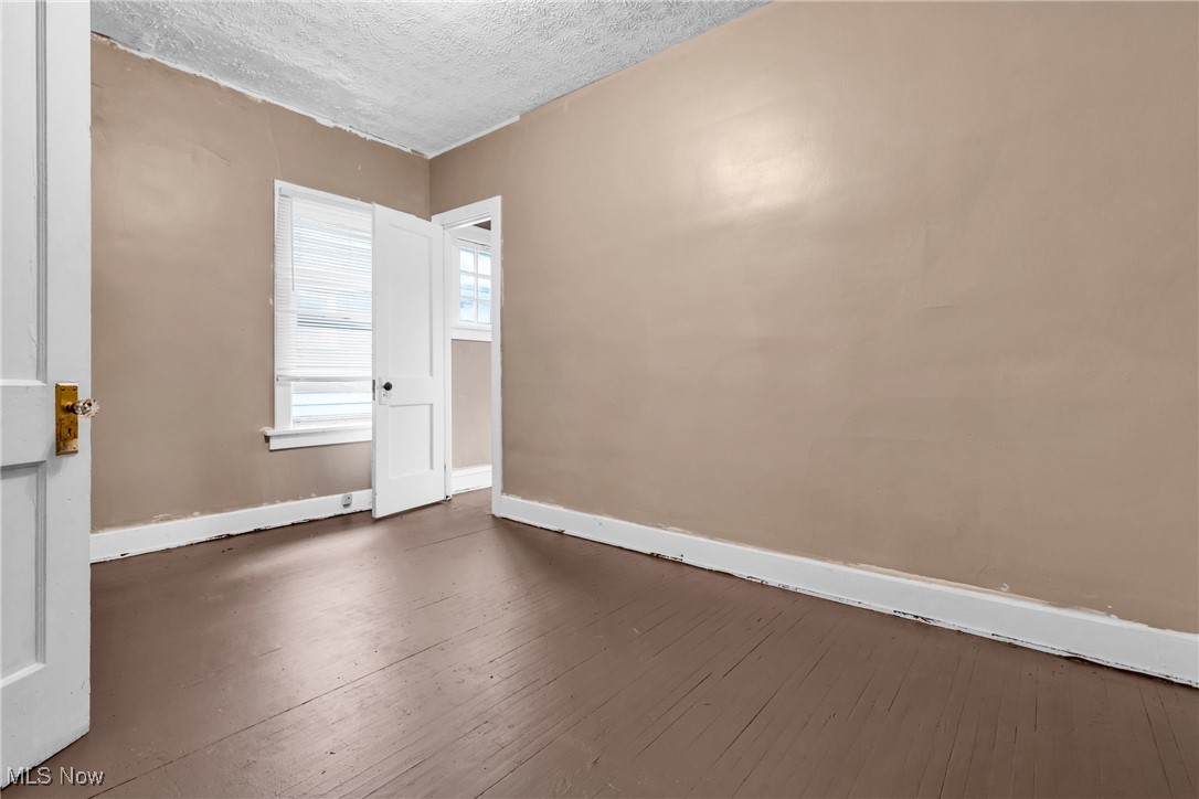 3770 Mayfield Road Cleveland Heights, OH 44121 - Photo 13 of 22 Spare room featuring a textured ceiling and dark wood-type flooring