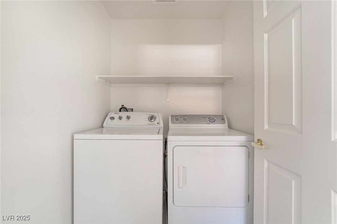 1570 Rusty Ridge Lane Henderson, NV 89002 - Photo 30 of 35 Clothes washing area featuring separate washer and dryer, laundry area, and visible vents